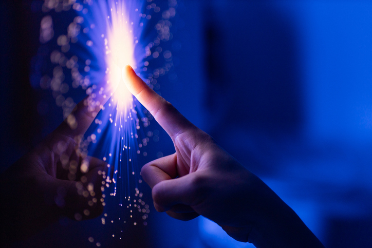 A finger touching optical fibers